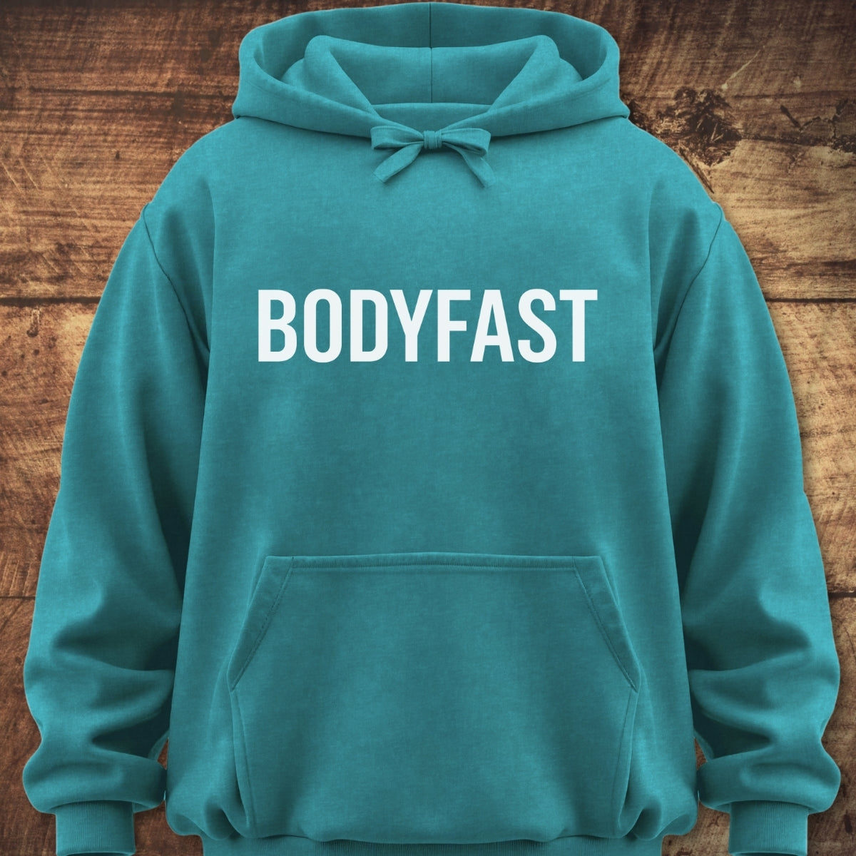 BODYFAST Hoodie featuring bold white lettering on the chest, a kangaroo pocket, and a hood with drawcords. Made from garment-dyed fleece, it offers a relaxed, unisex fit.