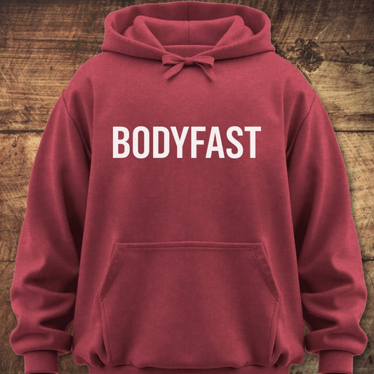BODYFAST Hoodie featuring a bold white logo on the chest, front kangaroo pocket, and drawstrings. Made from soft, garment-dyed 80/20 cotton-polyester fleece, offering a relaxed unisex fit for everyday comfort.