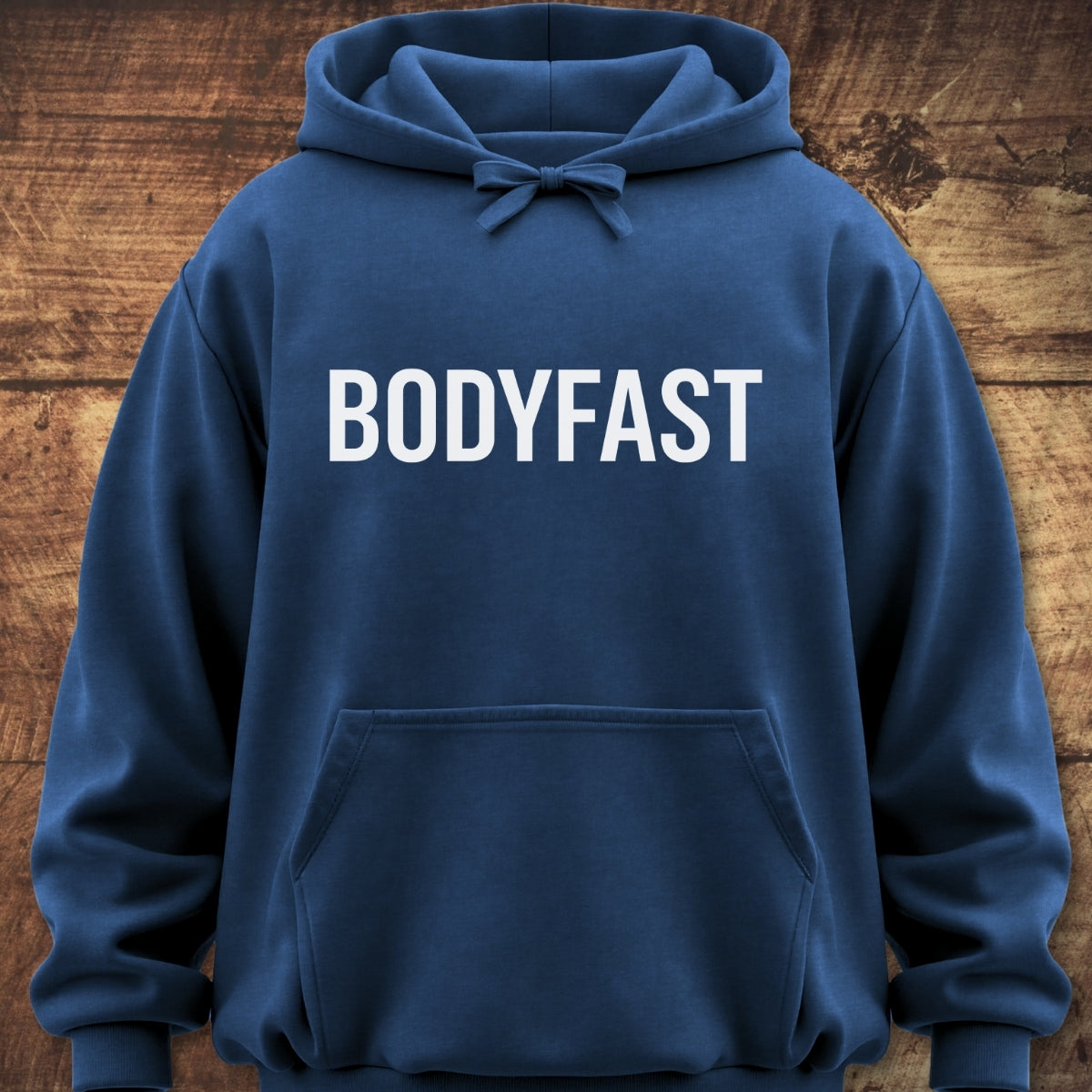 The BODYFAST Hoodie, a navy-blue pullover with a drawstring hood and kangaroo pocket, features bold white lettering across the chest, offering a relaxed fit ideal for outdoor adventures.