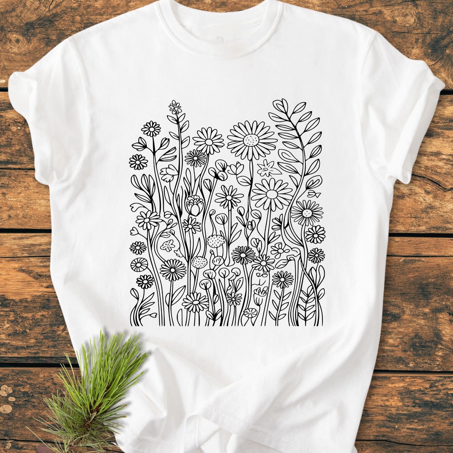 Wildflower Trails - Vintage Wash Tee displayed flat with a black line-drawing of wildflowers, designed for coloring or as a graphic, on soft, garment-dyed fabric, emphasizing comfort and durability.