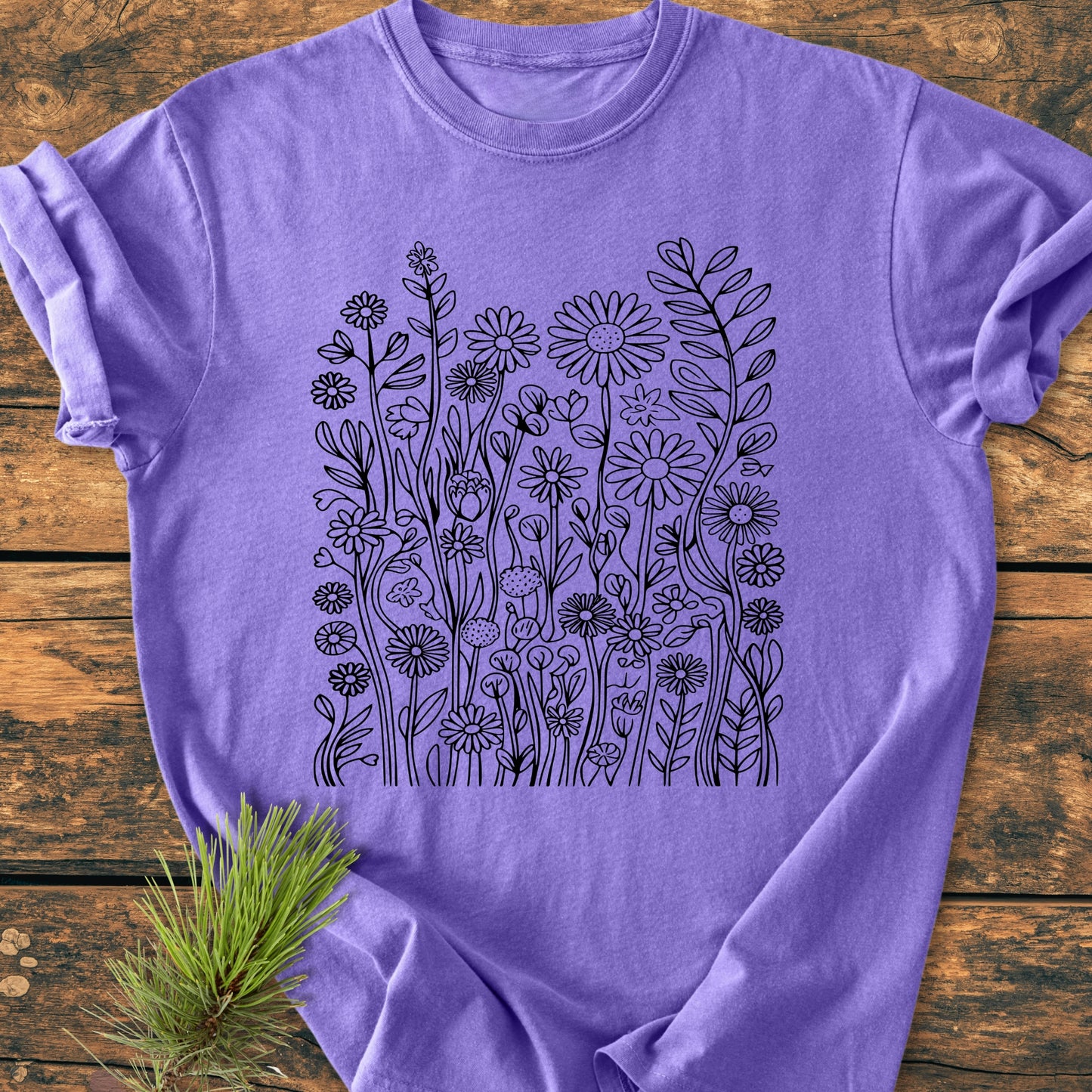 Wildflower Trails - Vintage Wash Tee displayed flat, showcasing intricate black wildflower line-art pattern across the front. Features relaxed fit, garment-dyed softness, and durable stitching for everyday comfort.