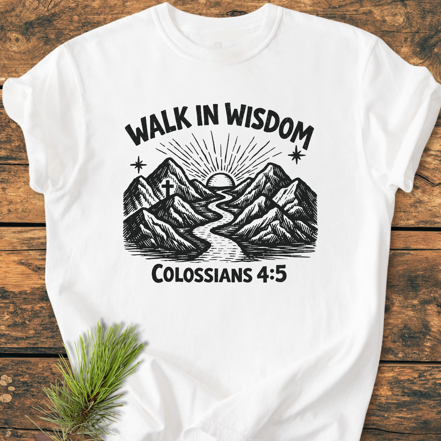 Walk In Wisdom, Colossians 4:5 - Vintage Wash Tee features a hand-drawn mountain and river graphic with sun, cross, and starbursts on soft white fabric, offering a comfortable, relaxed fit.