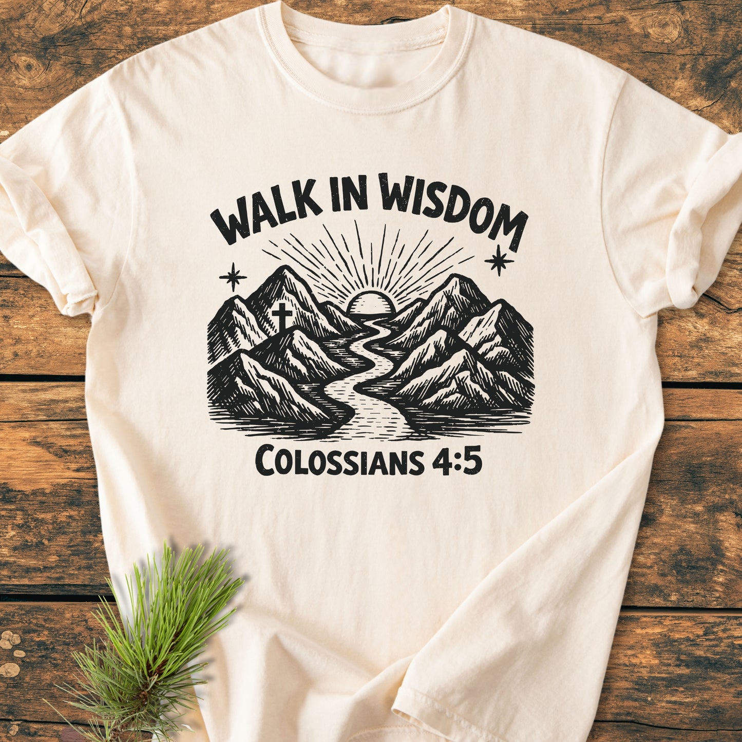 Walk In Wisdom, Colossians 4:5 - Vintage Wash Tee showcases a faith-inspired design with a mountain landscape, river, sun, and cross, printed on a cream-colored, soft, relaxed-fit T-shirt.