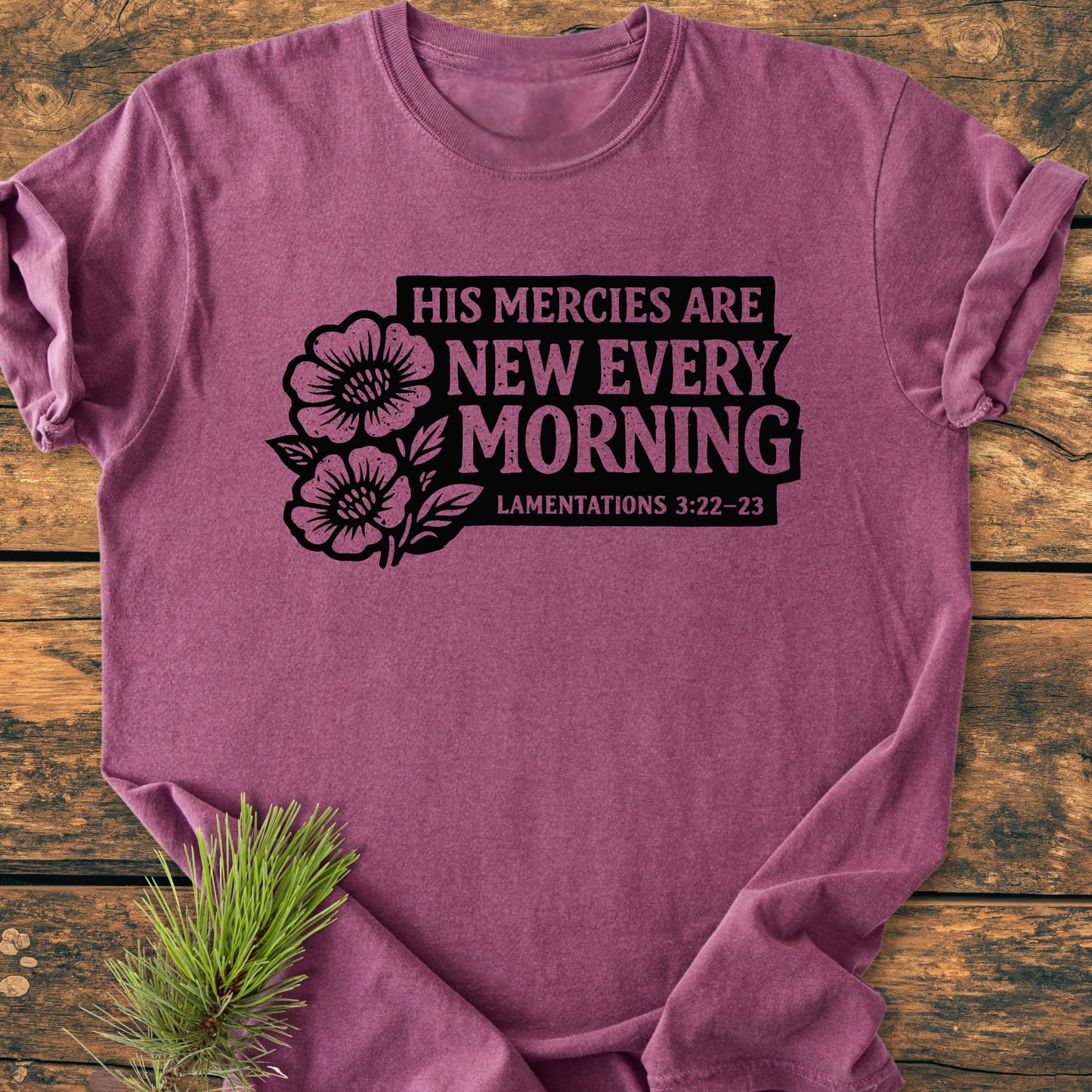 New Every Morning Lamentations 3:22-23 - Vintage Wash Tee, featuring a black floral graphic and Bible verse, flat-lay photographed on wood. Comfortable, relaxed fit, garment-dyed, pre-shrunk 100% cotton.