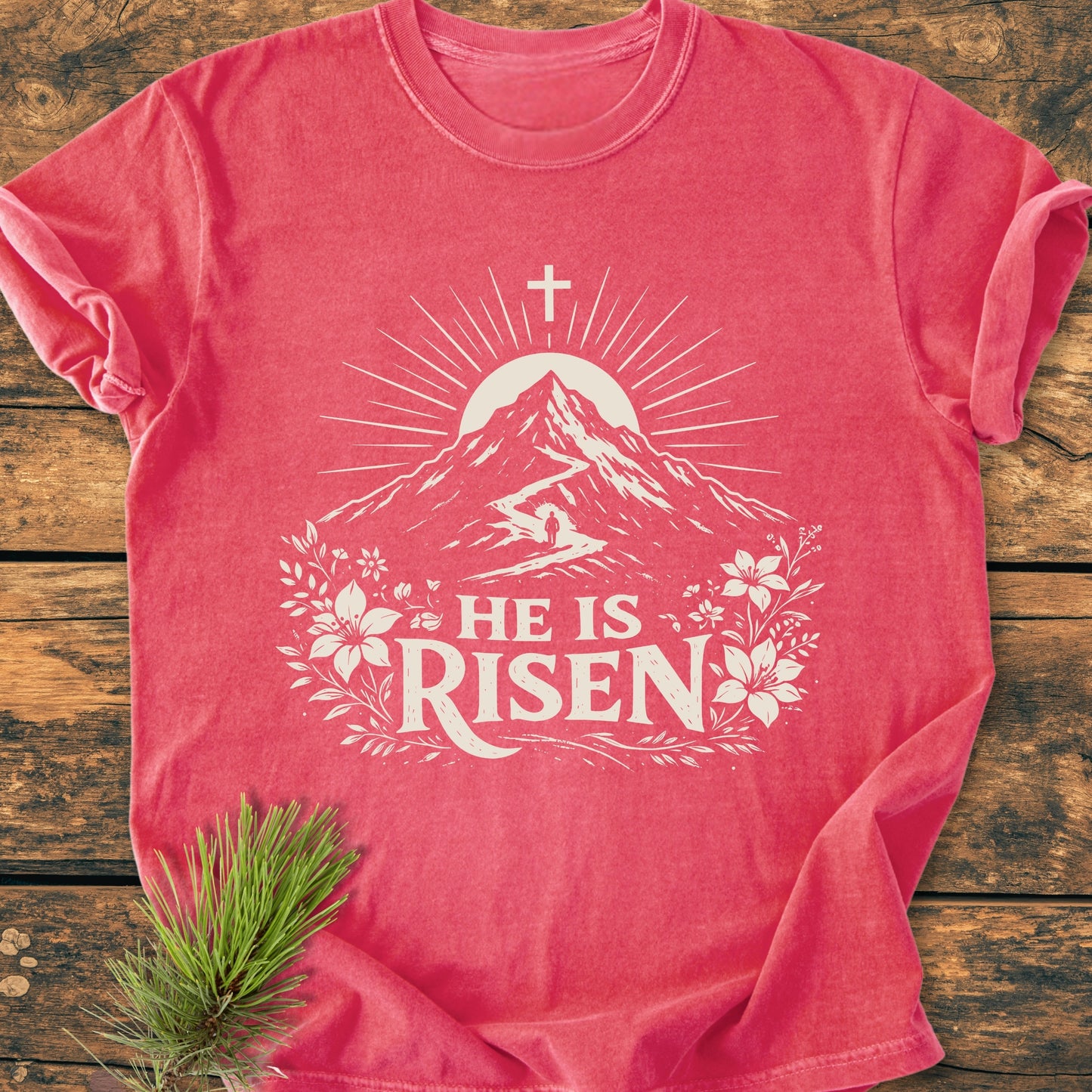 He Is Risen - Vintage Wash Tee features a stylized mountain with sun-rays and floral flourishes. Crafted from cozy, garment-dyed cotton, it’s perfect for daily wear, showcasing durability and comfort.