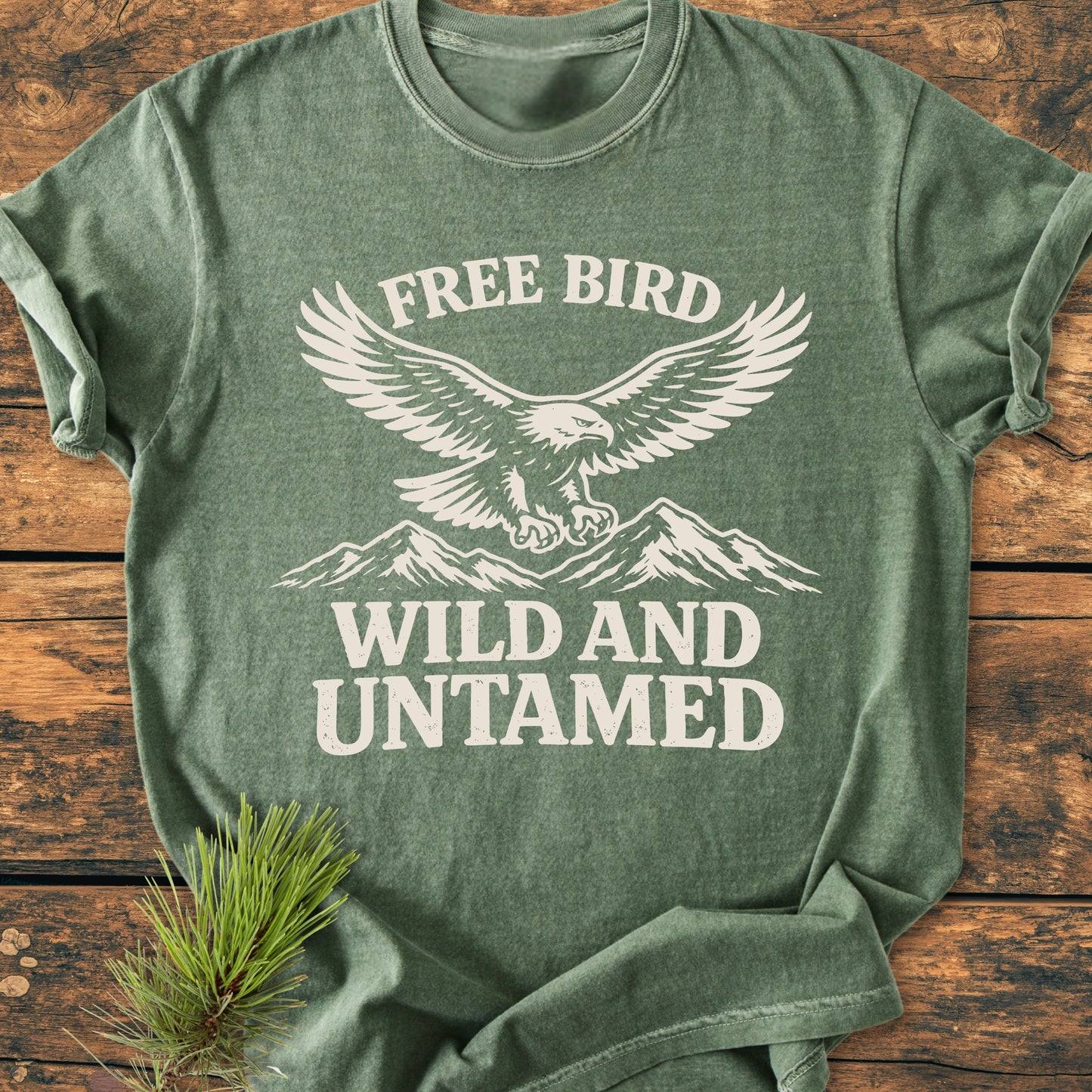Free Bird - Vintage Wash Tee featuring a stylized eagle over mountain peaks with FREE BIRD and WILD AND UNTAMED text, showcasing its relaxed fit and durable stitching.