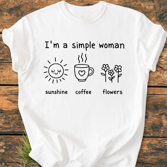 I'm A Simple Woman. Sunshine Coffee Flowers - Vintage Wash Tee displayed on wooden surface, featuring cute icons of a smiling sun, coffee mug, and flowers, on soft-washed, garment-dyed, 100% ring-spun cotton.