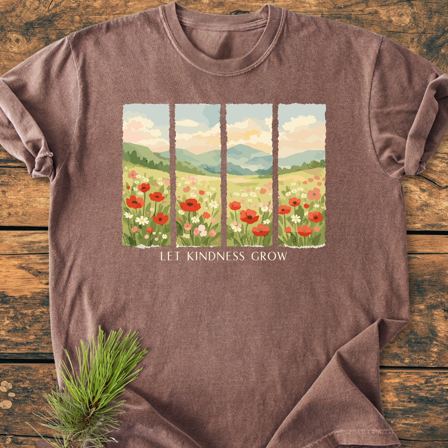 Let Kindness Grow - Vintage Heavyweight Tee features a four-panel illustration of wildflowers and hills, with LET KINDNESS GROW text, on soft brown, short-sleeve, garment-dyed cotton.