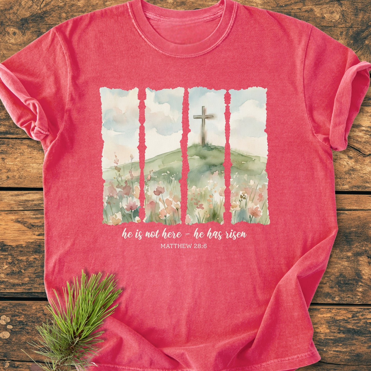 He Is Not Here. He Has Risen - Vintage Heavyweight Tee featuring a watercolor hill with a cross, text from Matthew 28:6. Laid flat, highlighting the shirt’s relaxed fit and durable stitching.