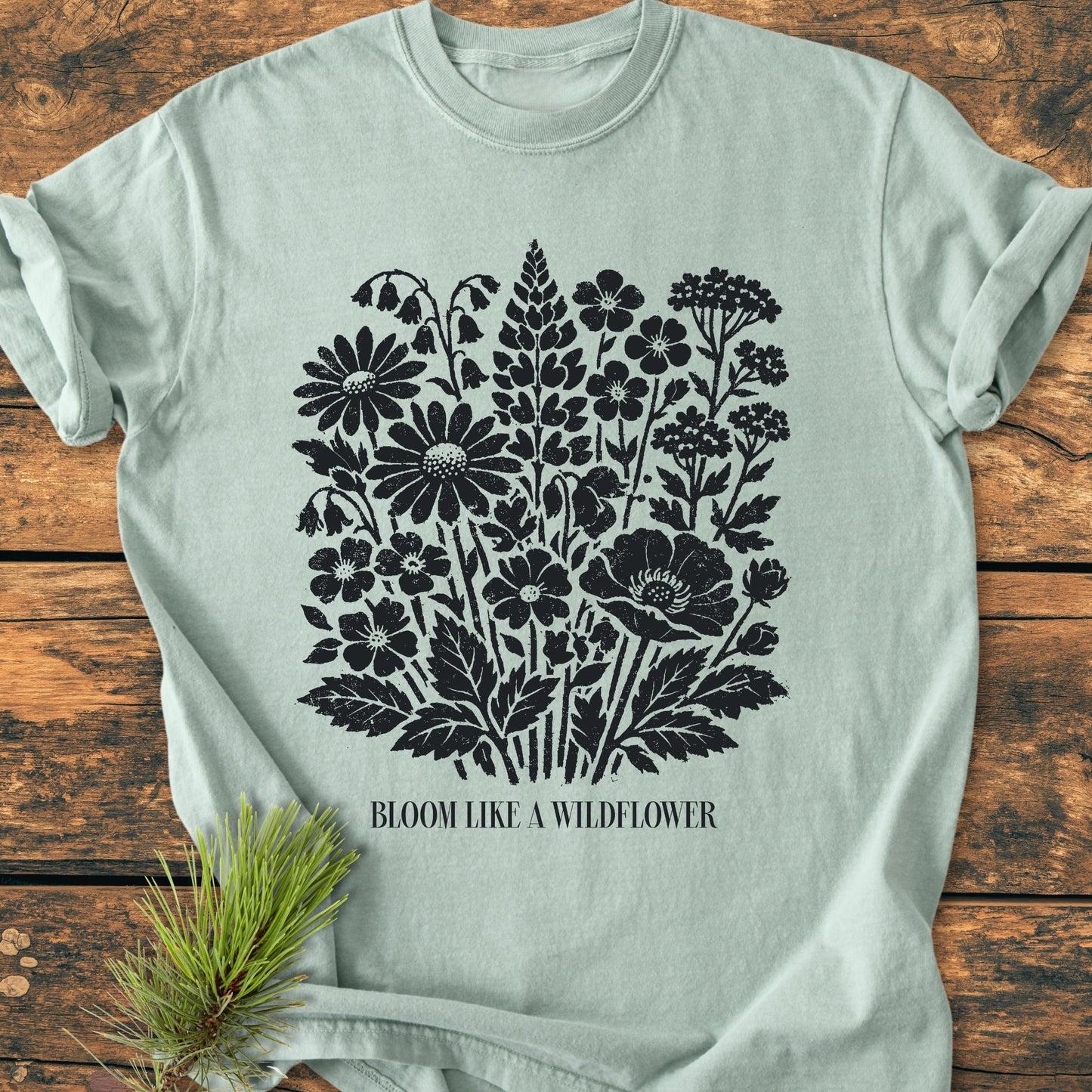 Bloom Like A Wildflower - Vintage Heavyweight Tee features a distressed wildflower bouquet graphic and BLOOM LIKE A WILDFLOWER text on a light-sage green, soft-washed, relaxed fit, 100% ring-spun cotton T-shirt.