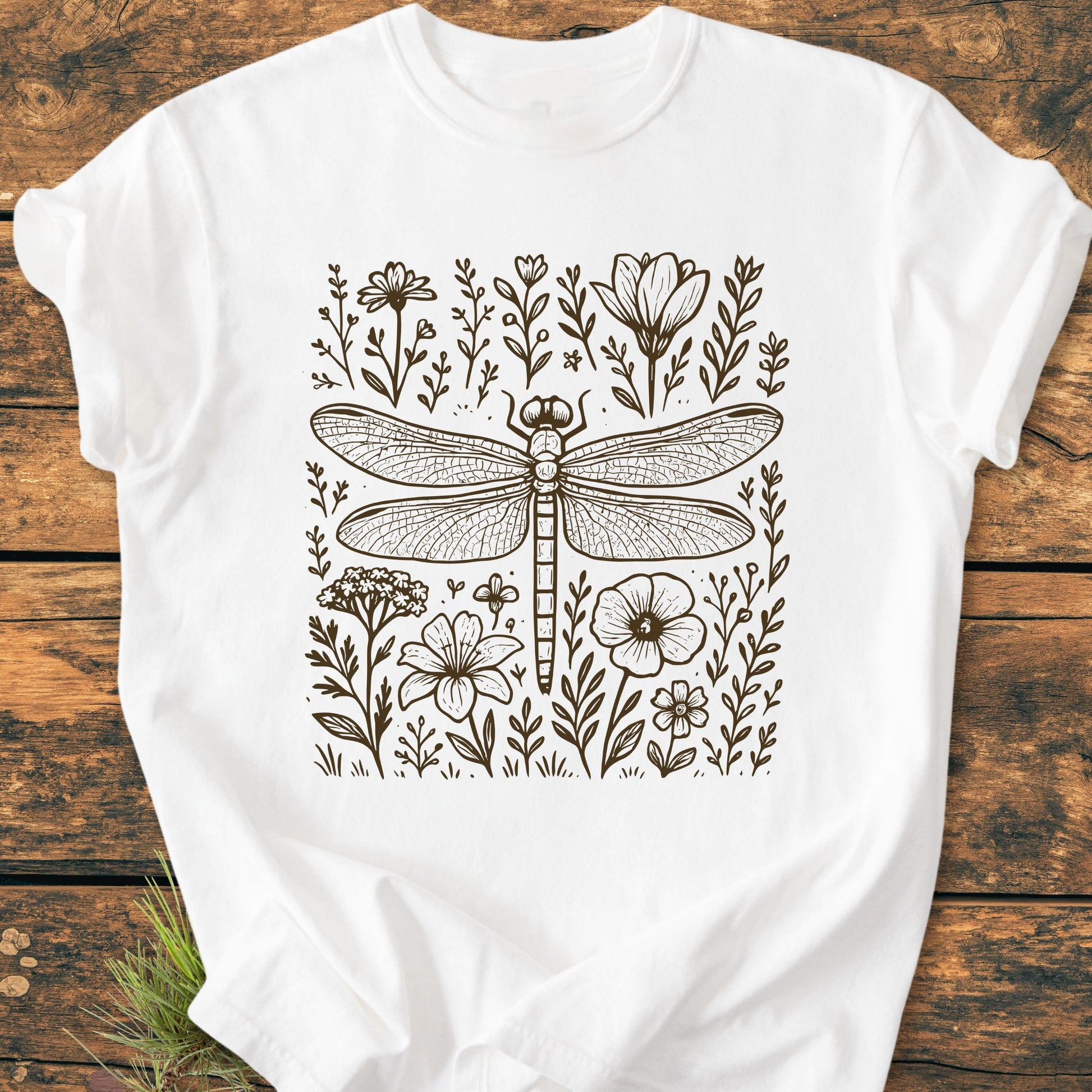 Dragonfly - Vintage Heavyweight Tee features a detailed dragonfly illustration with wildflowers on a soft, white T-shirt, emphasizing its relaxed fit and durable, garment-dyed, 100% ring-spun cotton fabric.