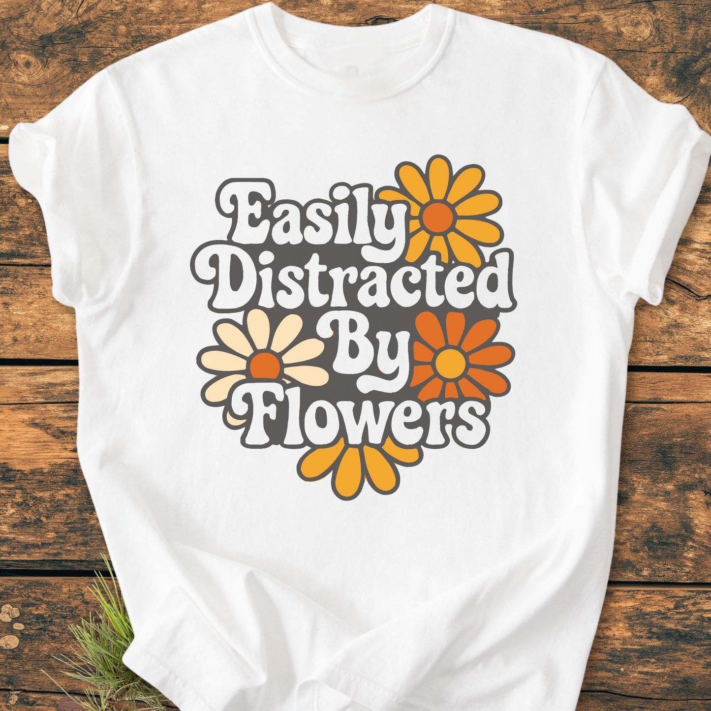 Easily Distracted By Flowers - Vintage Heavyweight Tee features a retro graphic of three daisylike flowers on a white T-shirt, showcasing a relaxed fit with durable stitching, ideal for everyday comfort.