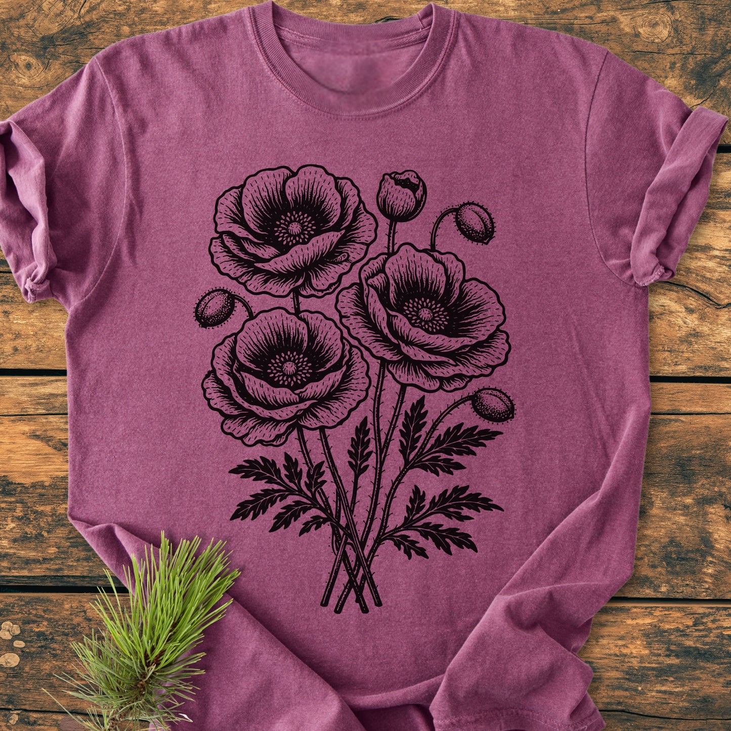 The Poppy Bouquet - Vintage Heavyweight Tee features a botanical poppy print on a soft, heather-purple T-shirt, offering comfort and durability with its relaxed fit and double-needle stitching.