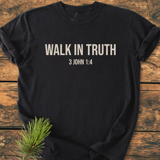 Walk In Truth - Vintage Wash Tee on wooden surface, featuring bold WALK IN TRUTH text and 3 JOHN 1:4 reference; made from soft, durable 100% ring-spun cotton, relaxed fit.