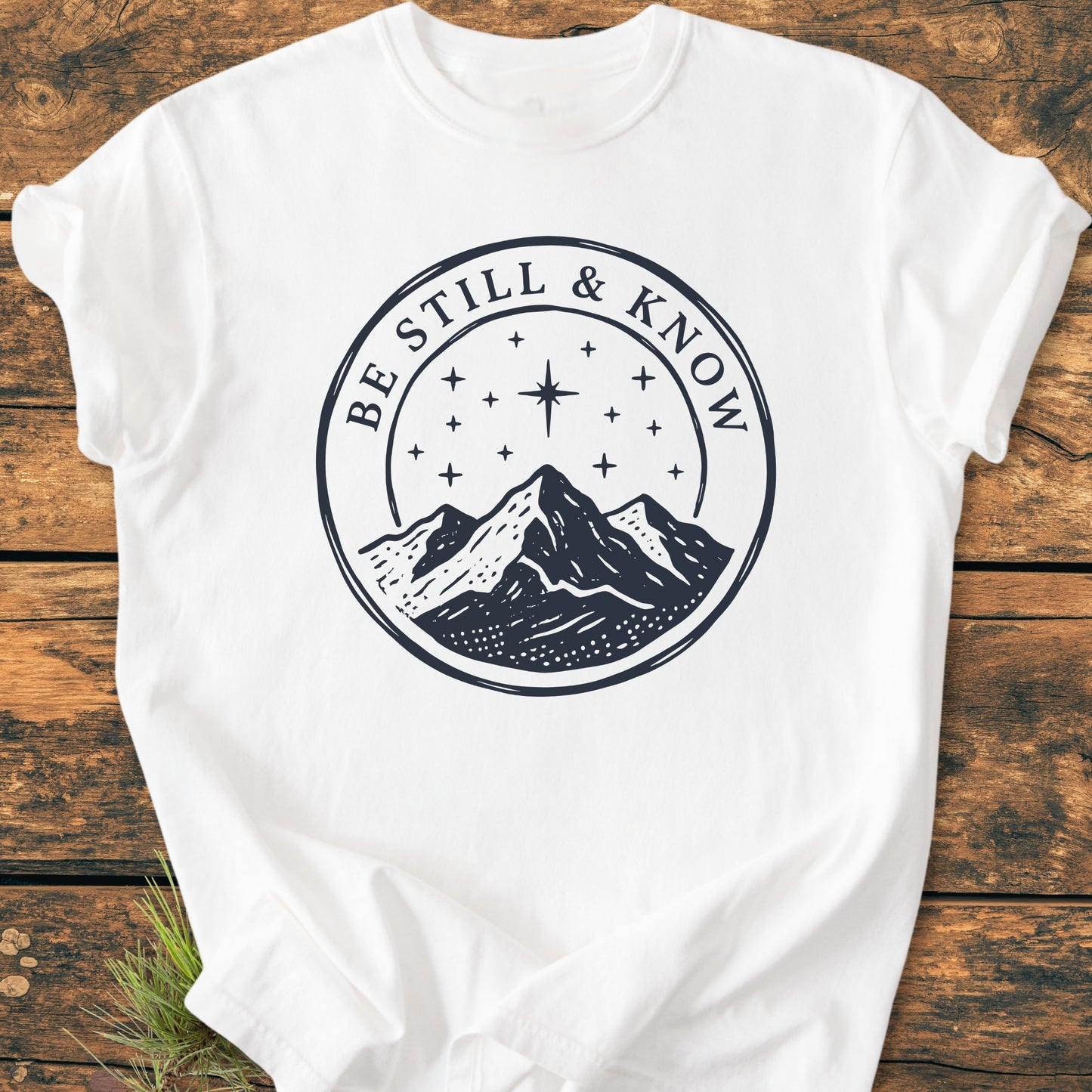 Be Still And Know, Psalm 46:10 - Vintage Wash Tee features a circular emblem with a mountain range and starry sky. The relaxed fit, garment-dyed T-shirt is crafted from soft, 100% ring-spun cotton.
