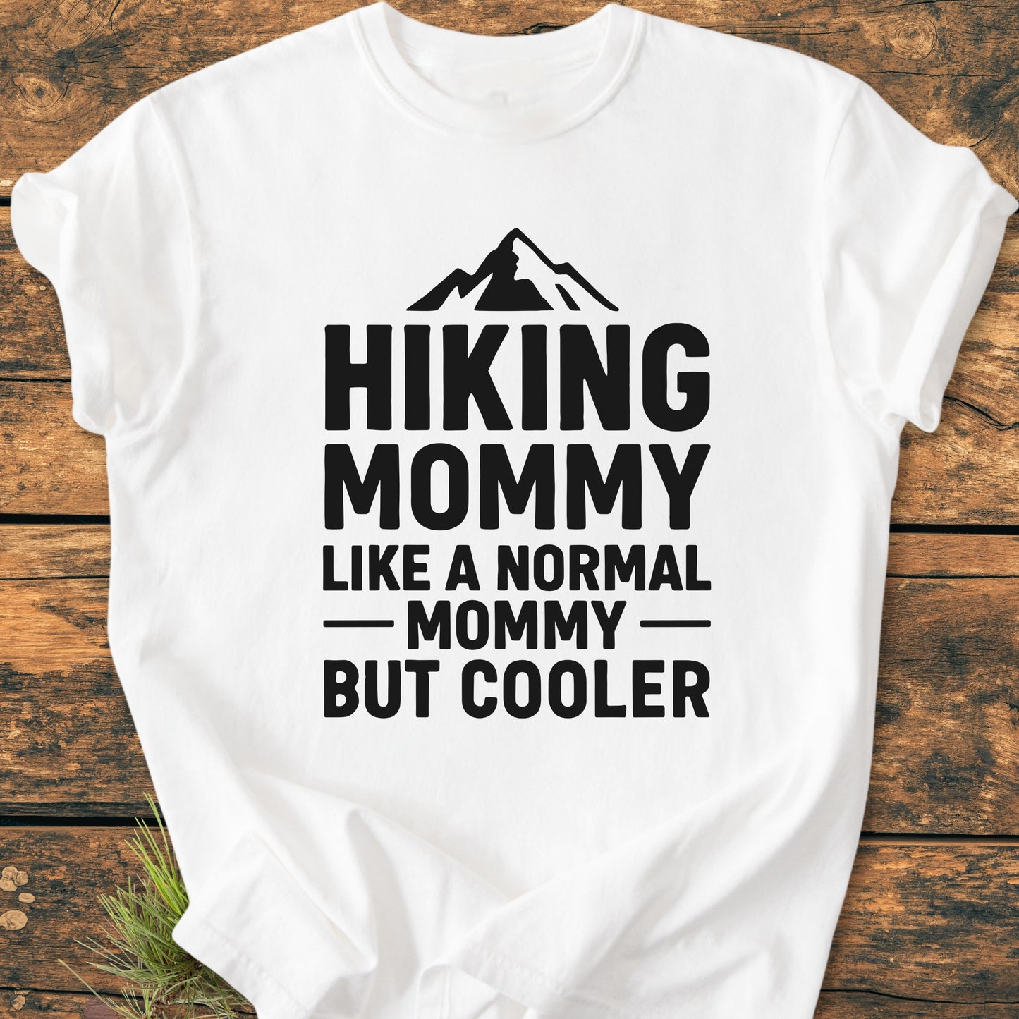 Hiking Mommy - Vintage Heavyweight Tee displays a black mountain silhouette and bold text on a white T-shirt, highlighting its relaxed fit and durable, soft-washed fabric.