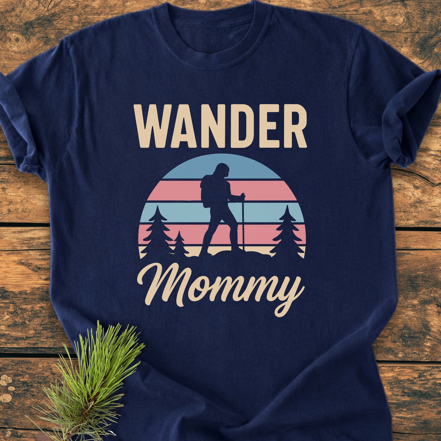 Navy-blue Wander Mommy Retro - Vintage Heavyweight Tee features a hiker silhouette among trees with a pastel-striped sunset. Crafted from soft, ring-spun cotton, offering a relaxed fit and durable construction.