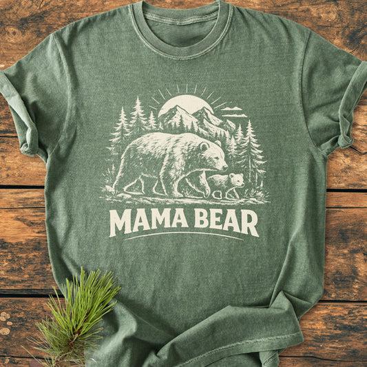Mama Bear - Vintage Heavyweight Tee features a woodland scene with a bear and cub, printed on a heather-green T-shirt. The soft-washed, relaxed fit ensures comfort and durability.