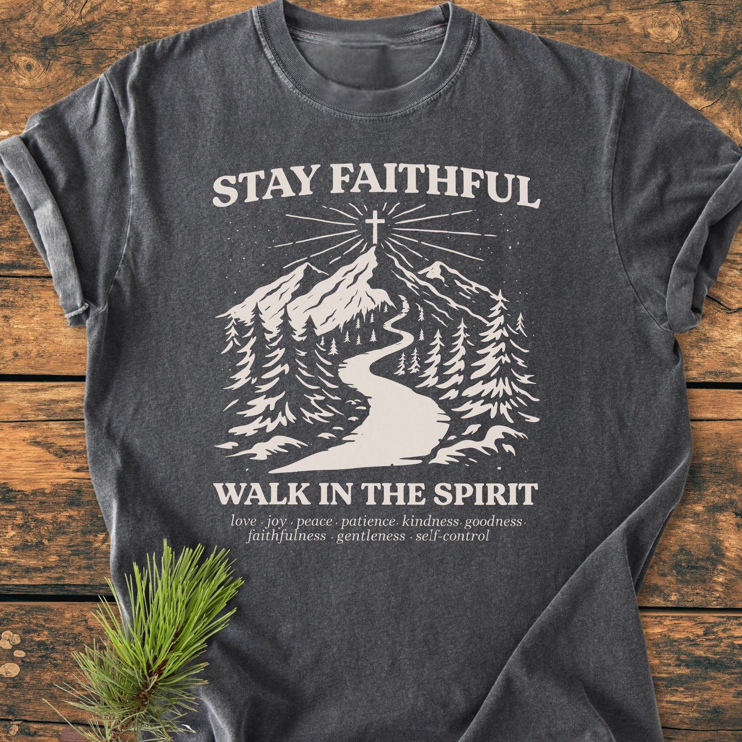 Stay Faithful - Vintage Heavyweight Tee features a white print of a mountain path scene on a charcoal-gray T-shirt, emphasizing spiritual themes with words like love and peace.