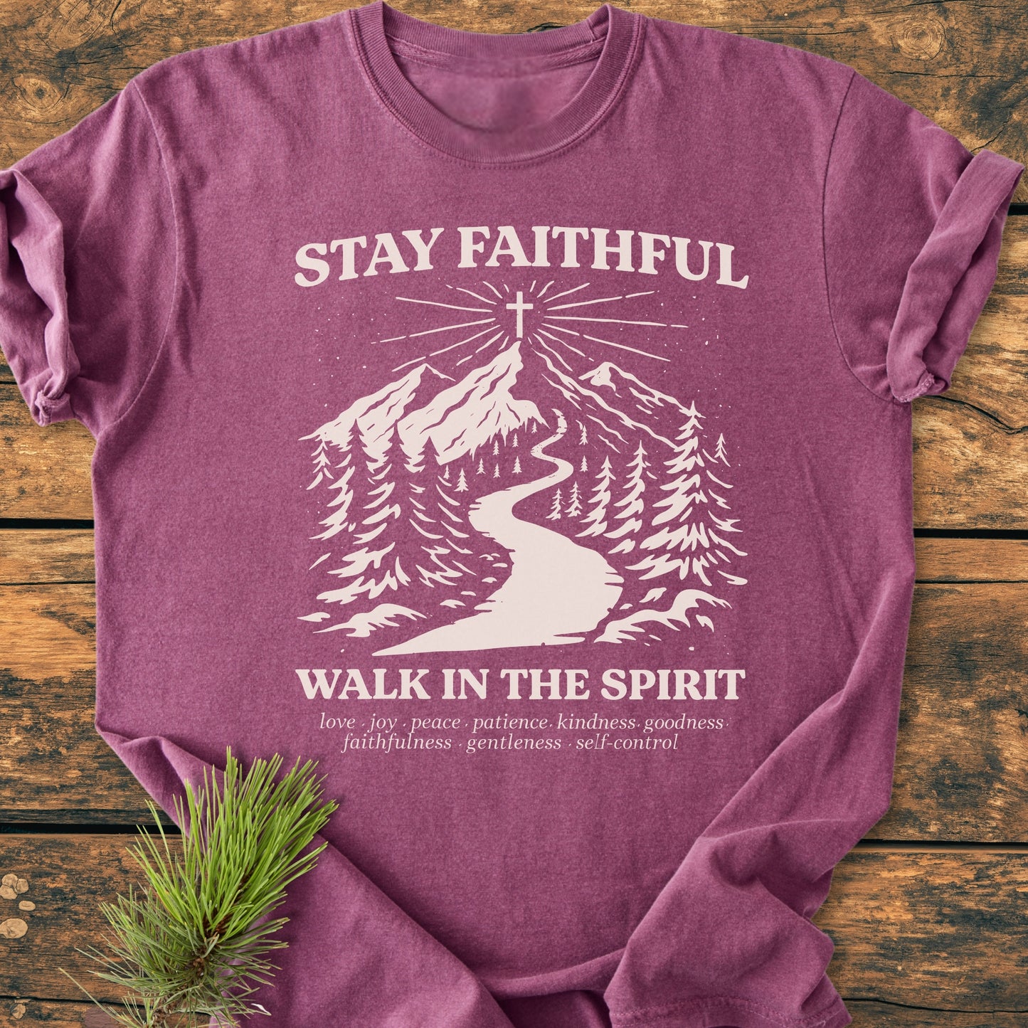 Stay Faithful - Vintage Heavyweight Tee features a forest path graphic with a cross, slogan, and virtues list on a heather-purple T-shirt, laid flat with pine sprig accent.