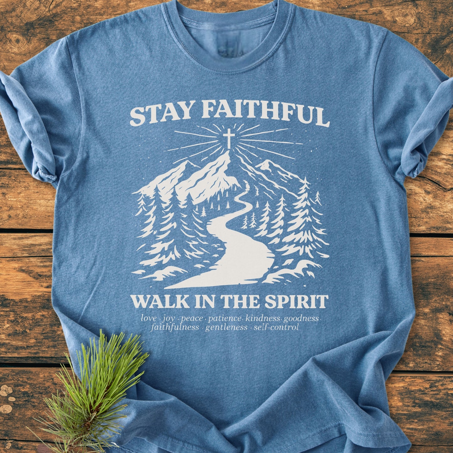 Stay Faithful - Vintage Heavyweight Tee features a mountain path graphic with a cross, emphasizing faith and spiritual growth, on a blue T-shirt laid flat, showcasing its relaxed fit and durability.