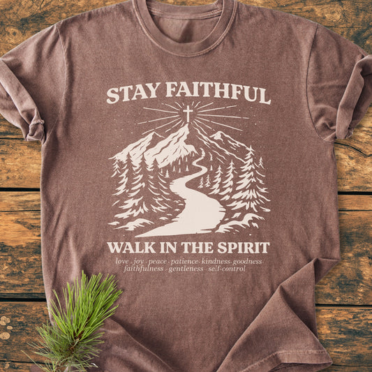 Stay Faithful - Vintage Heavyweight Tee features a stylized mountain scene with pine trees and a hilltop cross, overlaid with spiritual messages. Made from cozy, durable, 100% ring-spun cotton.