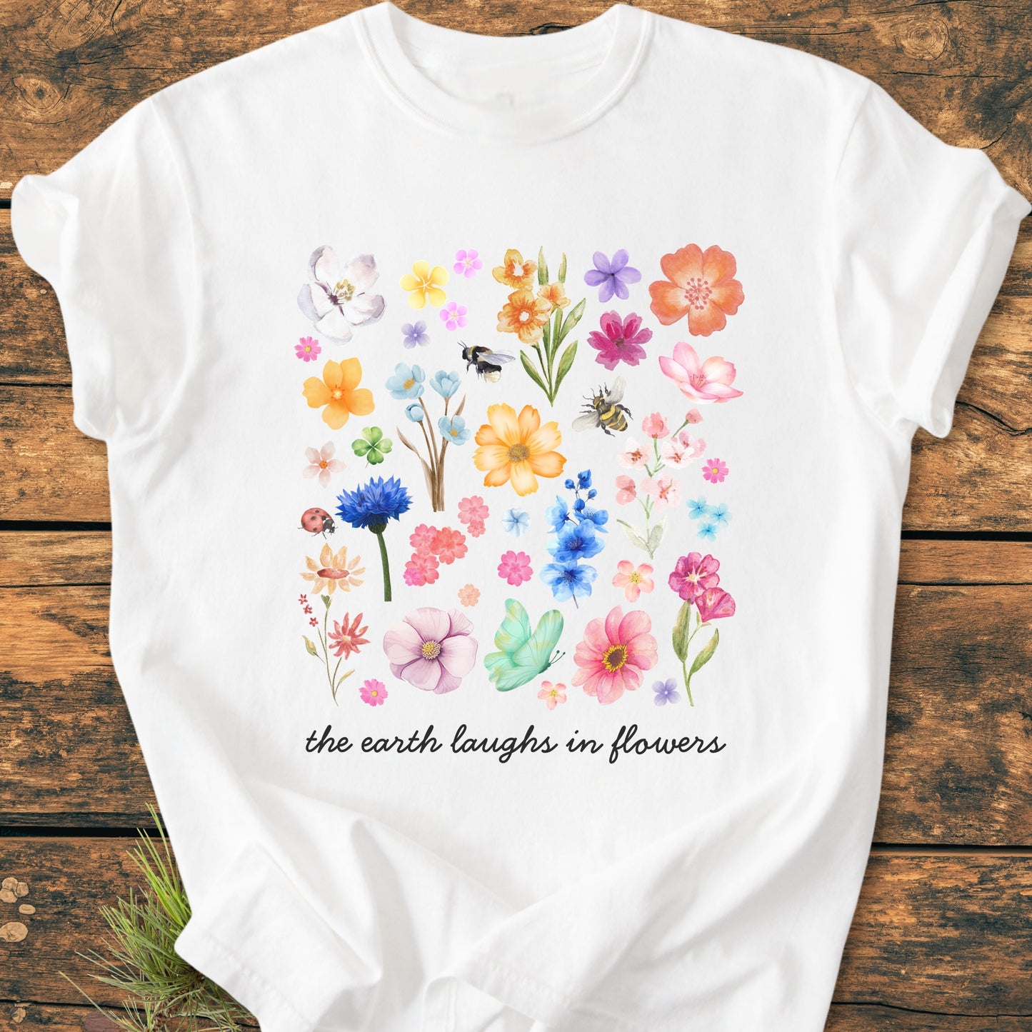The Earth Laughs In Flowers - Vintage Heavyweight Tee features a watercolor-style floral collage with insects and the scripted phrase, adding charm to this relaxed, garment-dyed, 100% ring-spun cotton T-shirt.