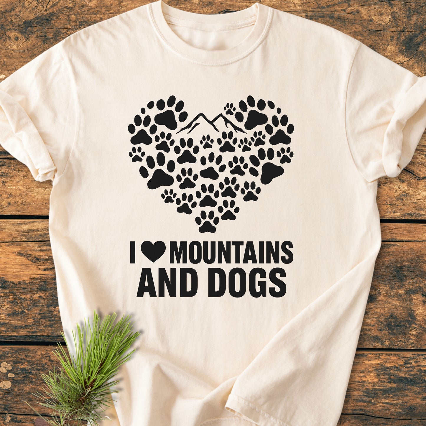 Paw Heart Dog Lover - Vintage Heavyweight Tee features a heart of black dog-paw silhouettes with a mountain outline, and the text “I ♥ MOUNTAINS AND DOGS” on soft, garment-dyed fabric.