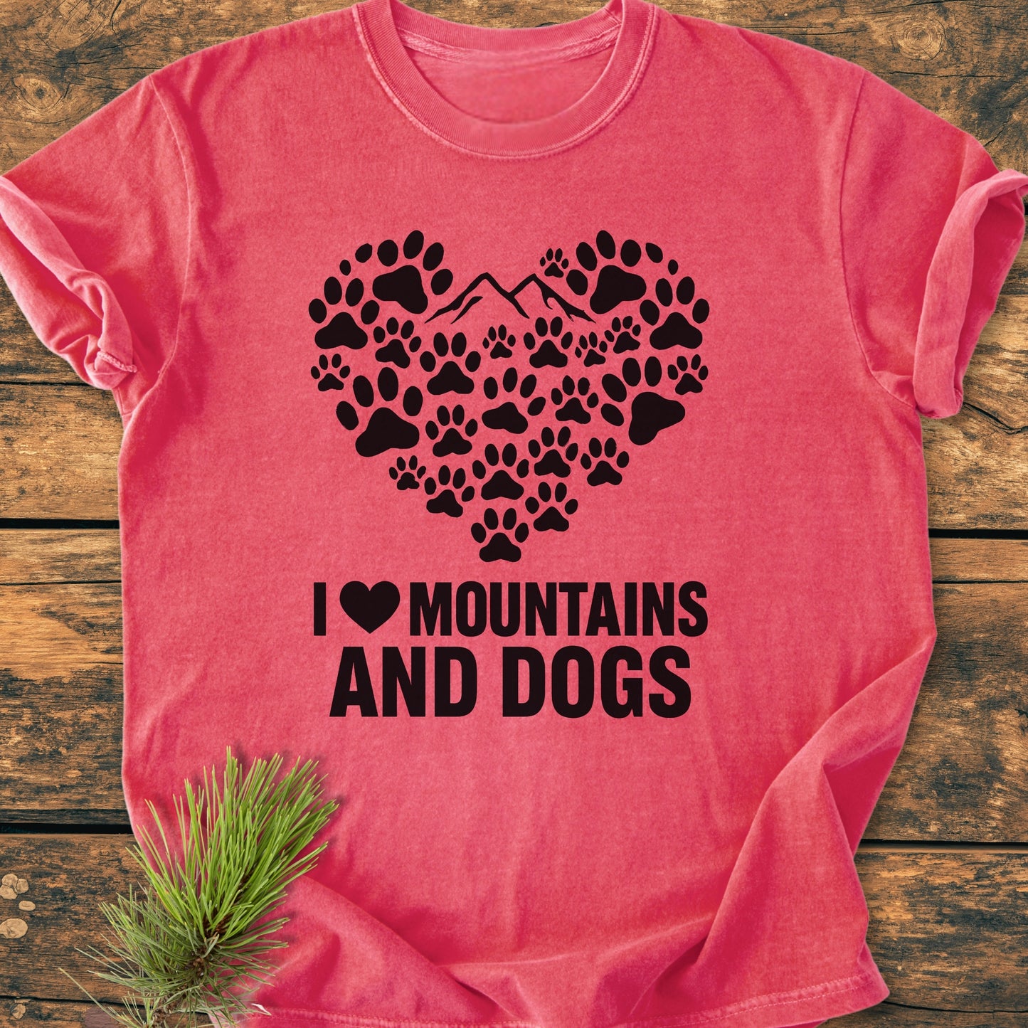 Paw Heart Dog Lover - Vintage Heavyweight Tee showcases a heart-shaped dog paw graphic with a mountain silhouette on a relaxed fit t-shirt, laid flat with a pine branch accent.