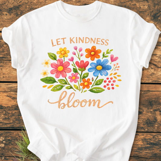 Let Kindness Bloom - Vintage Wash Tee features a hand-painted floral bouquet with 'LET KINDNESS bloom' text, displayed on a soft, garment-dyed white T-shirt on a rustic surface.