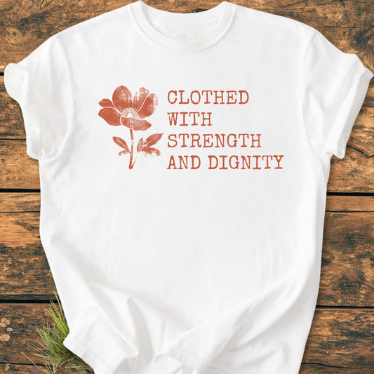 Clothed With Strength And Dignity, Proverbs 31:25 - Vintage Heavyweight Tee: White crew-neck T-shirt with rust-orange flower and text design, showcasing comfort and durability on a rustic wooden background.