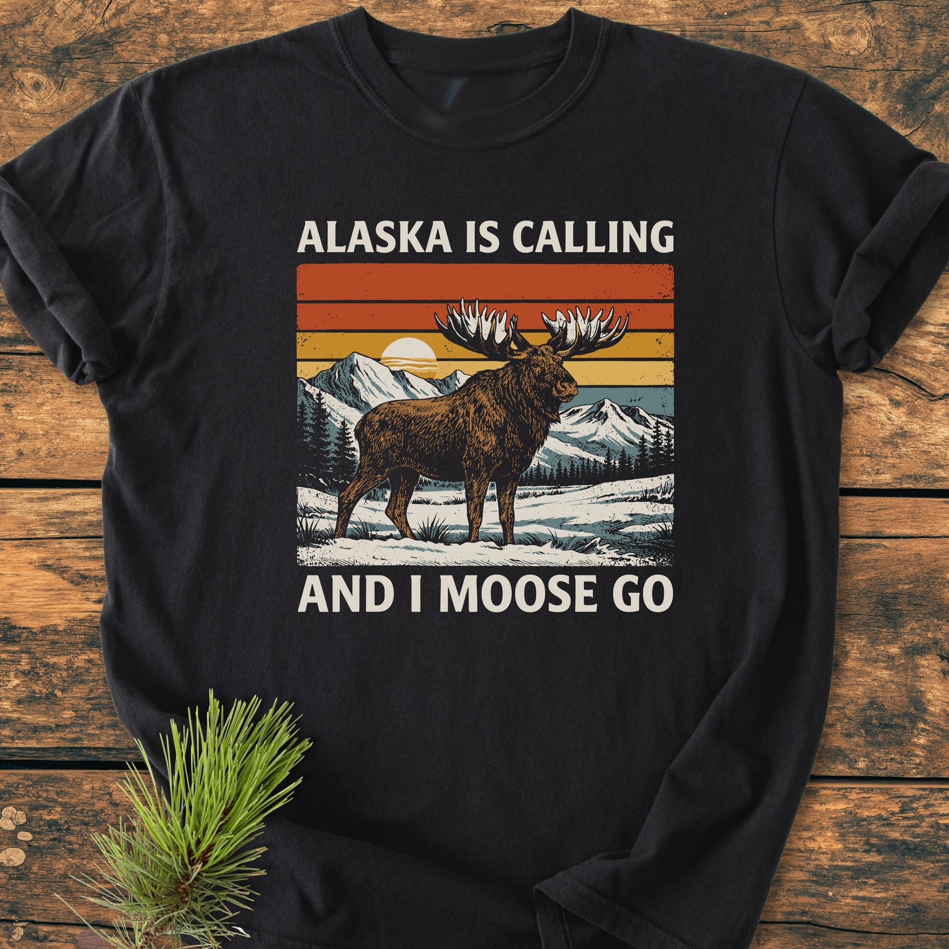 Alaska Is Calling - Vintage Wash Tee features a retro moose graphic in a snowy landscape, embodying tranquility and faith. Perfect for nature lovers seeking comfort and inspiration in God's creation.