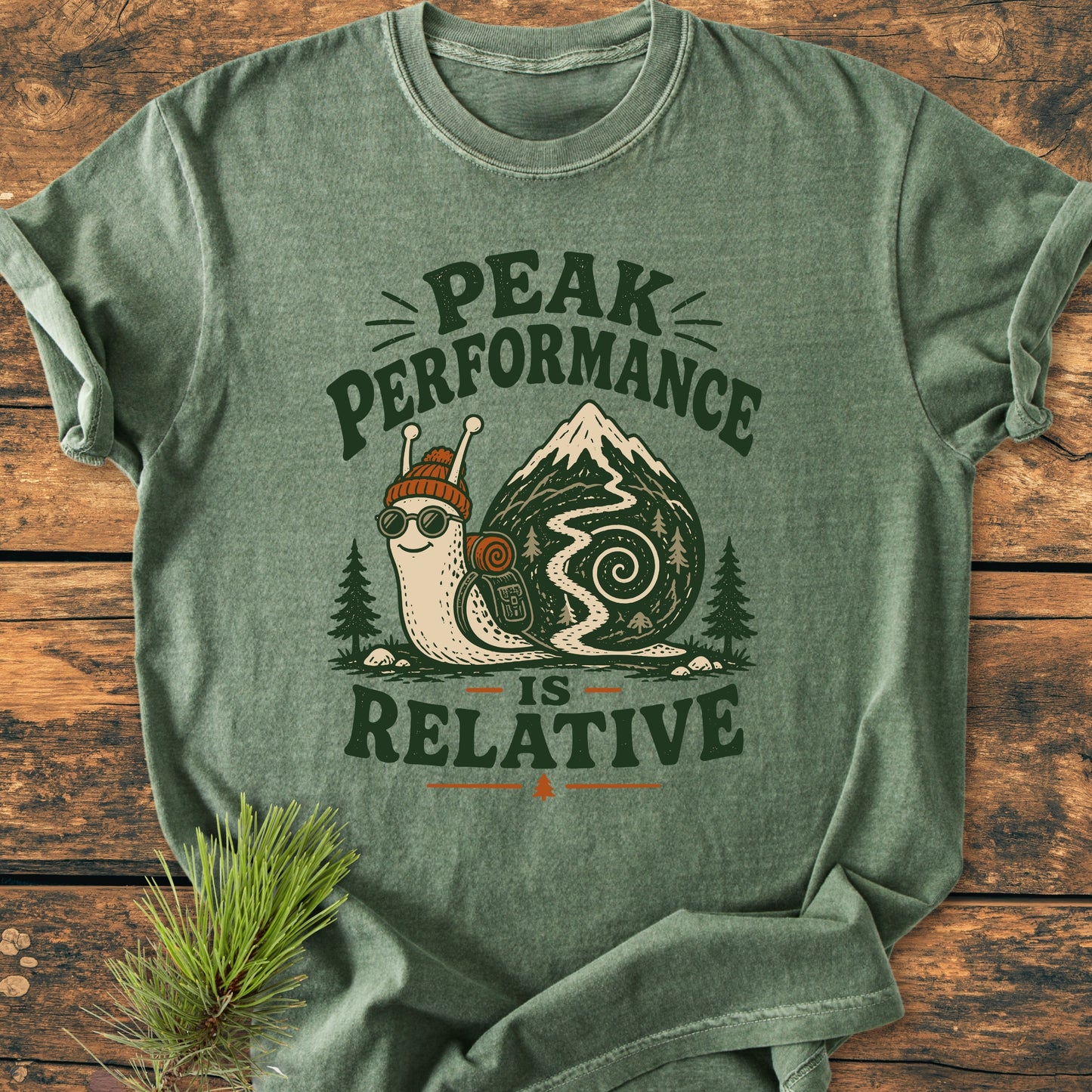 Peak Performance Is Relative - Vintage Wash Tee features a cartoon snail with a knit cap and backpack on a mountain trail, perfect for leisurely hikers and laid-back adventurers.