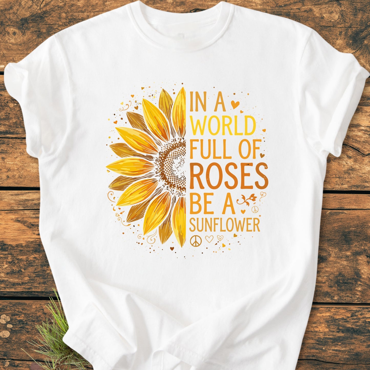 Be A Sunflower - Vintage Wash Tee featuring a large, stylized half-sunflower and motivational slogan, laid on a wooden surface, designed for nature lovers and those embracing individuality.