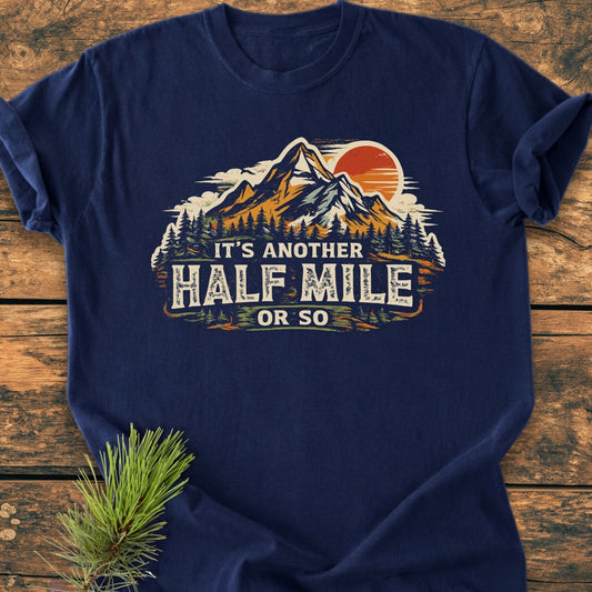 Another Half Mile Or So - Vintage Wash Tee featuring a stylized mountain scene with pine trees and an orange sun, showcasing a relaxed fit and soft, durable fabric ideal for hiking enthusiasts.