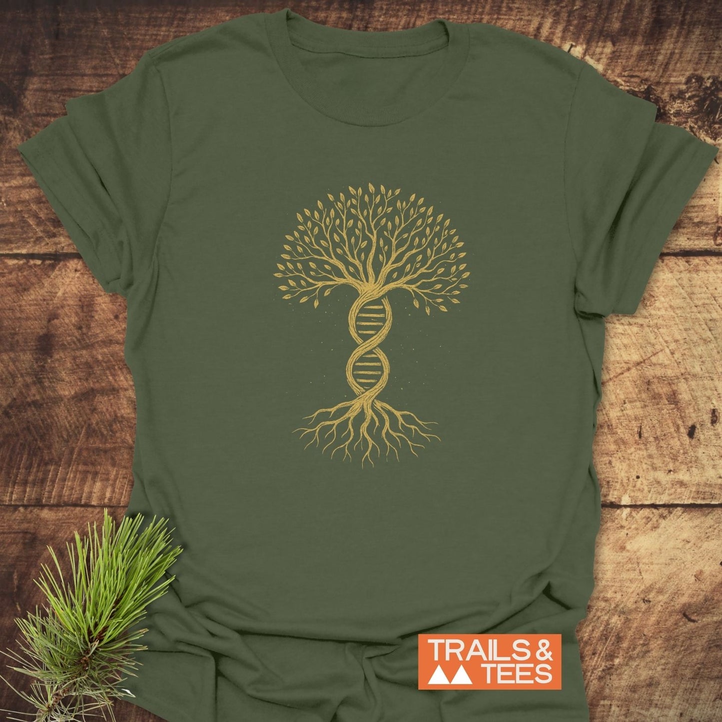 Tree Of Life T-Shirt featuring a golden DNA double helix transforming into a tree, symbolizing growth and nature, laid flat on a wooden surface with a pine sprig accent.