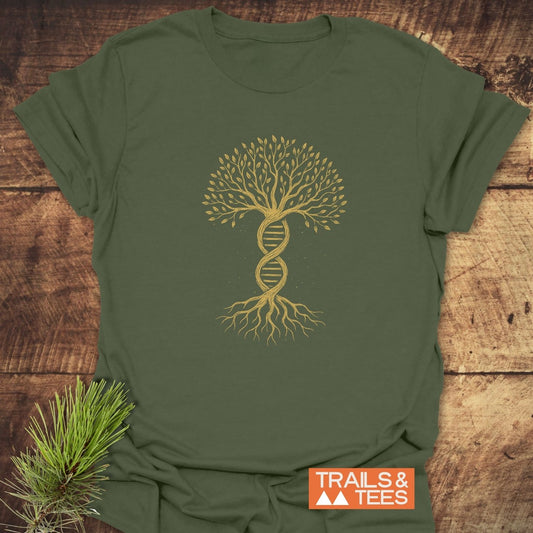 Tree Of Life T-Shirt featuring a golden DNA double helix transforming into a tree, symbolizing growth and nature, laid flat on a wooden surface with a pine sprig accent.