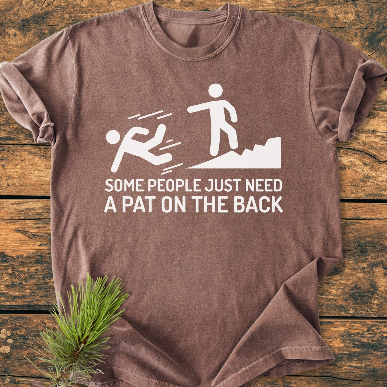 Some People Just Need A Pat On The Back - Vintage Wash Tee features a humorous stick-figure graphic with a playful caption, laid flat showcasing its relaxed fit suitable for hikers.
