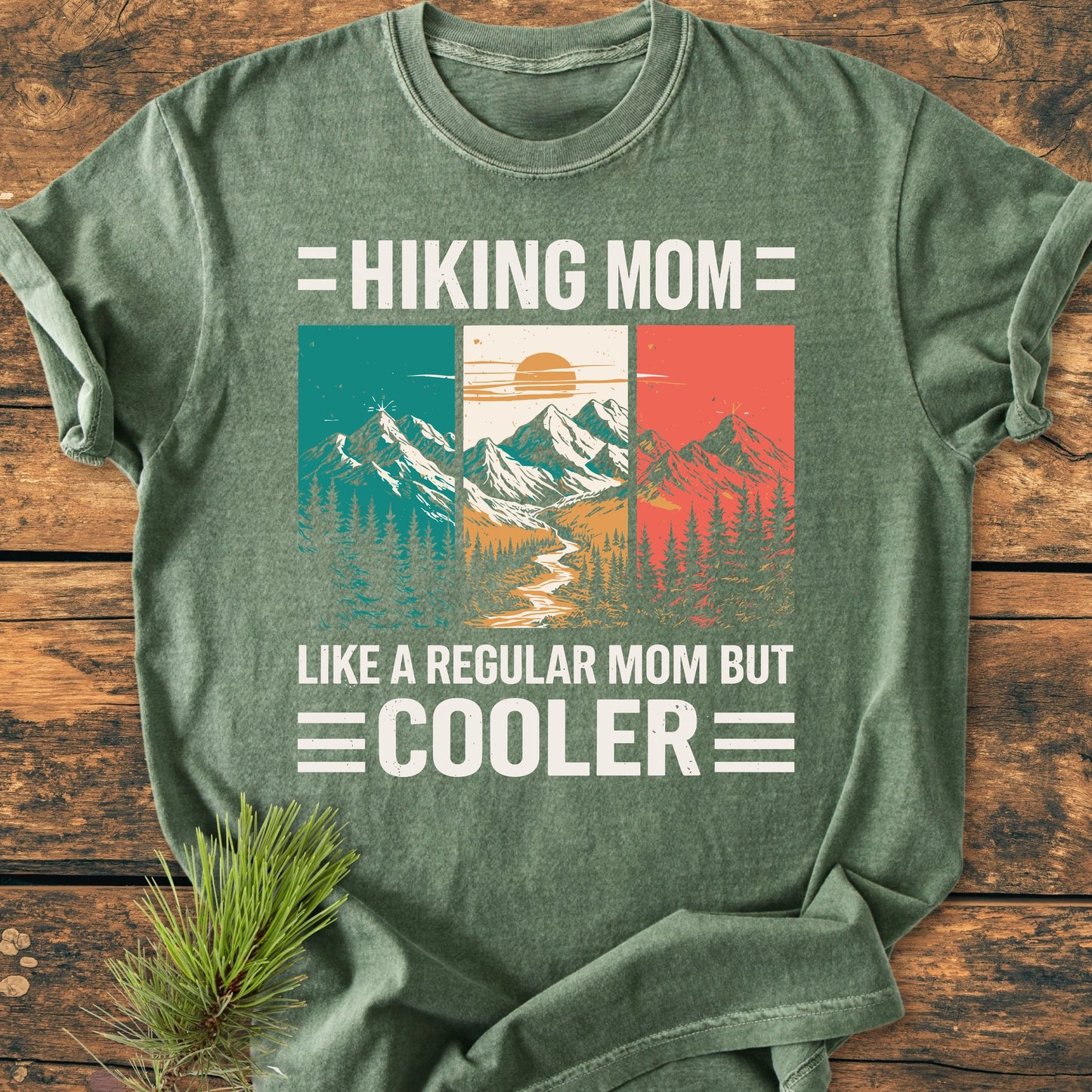 Hiking Mom - Vintage Wash Tee features a retro mountain graphic with text, laid on wood. Made of soft, garment-dyed cotton, it's both cozy and durable, ideal for casual wear.