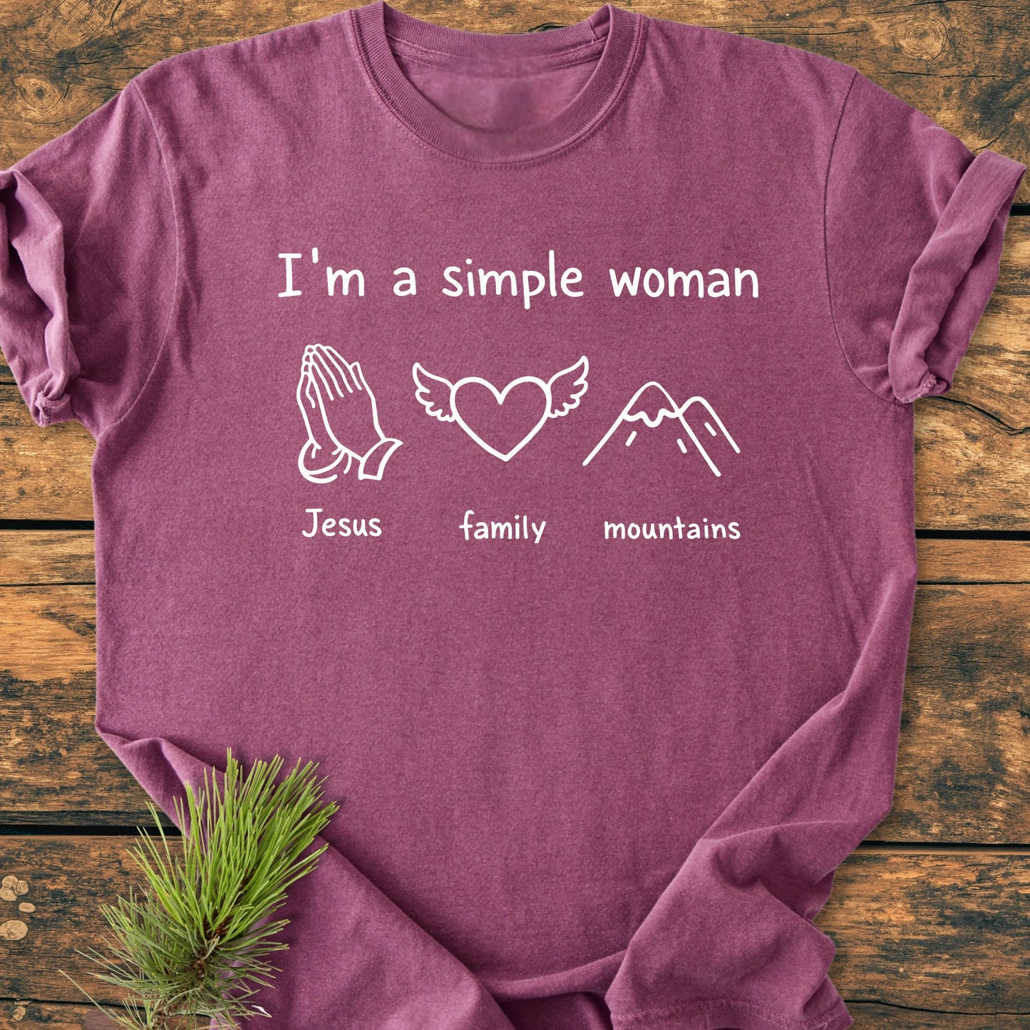 Heathered plum T-shirt reading I'm a Simple Woman with icons for Jesus, family, and mountains, showcasing a vintage wash and relaxed fit, perfect for everyday wear.