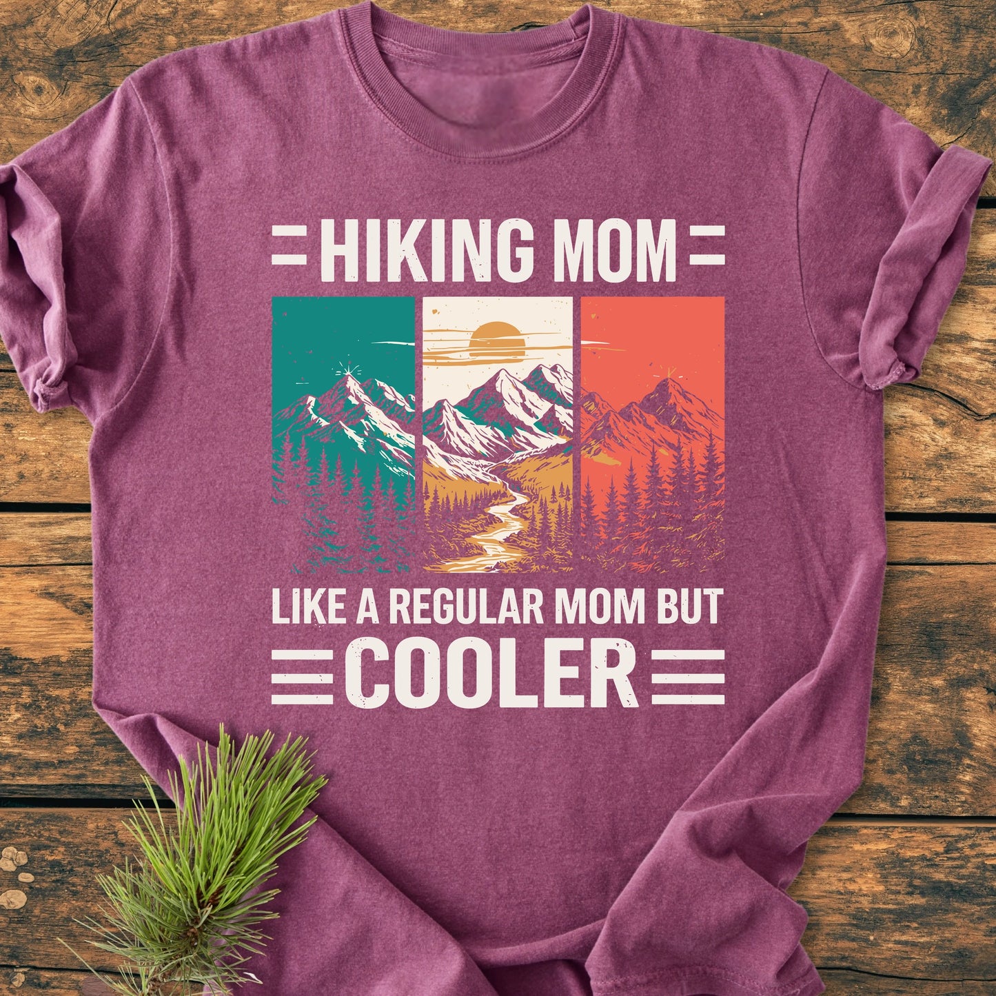 Hiking Mom - Vintage Wash Tee: A heather-purple T-shirt featuring a vintage mountain scene with trees and river, and the phrases “HIKING MOM” and “LIKE A REGULAR MOM BUT COOLER.”