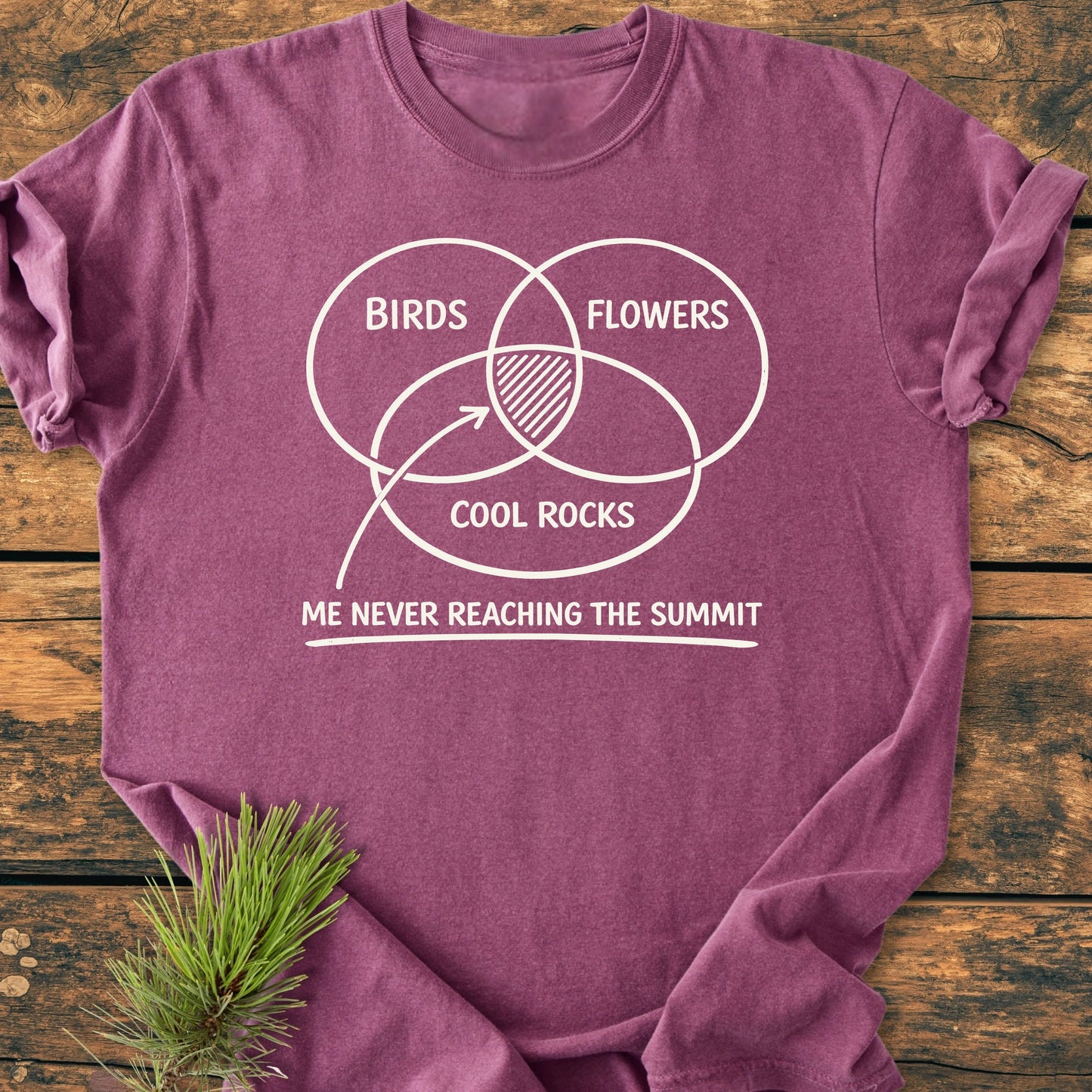 The 1416 Easily Distracted Hiker T-shirt features a whimsical Venn diagram with BIRDS, FLOWERS, and COOL ROCKS, humorously highlighting distractions during hikes, on a soft, relaxed-fit tee.