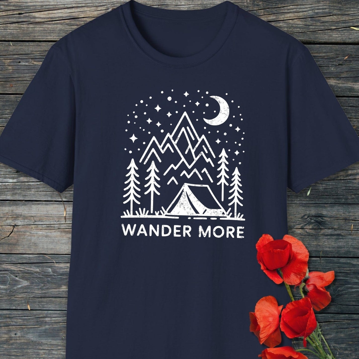 Wander More T-Shirt featuring a distressed camping scene graphic with pine trees, mountains, and moon; crafted from soft, durable cotton for outdoor enthusiasts.