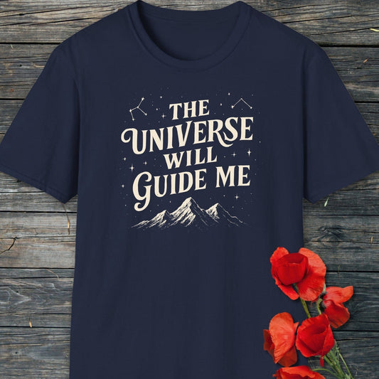 The Universe Guides Me T-Shirt with vintage text, star illustrations, and mountain graphic on soft navy cotton, accompanied by vibrant red poppies on wood.