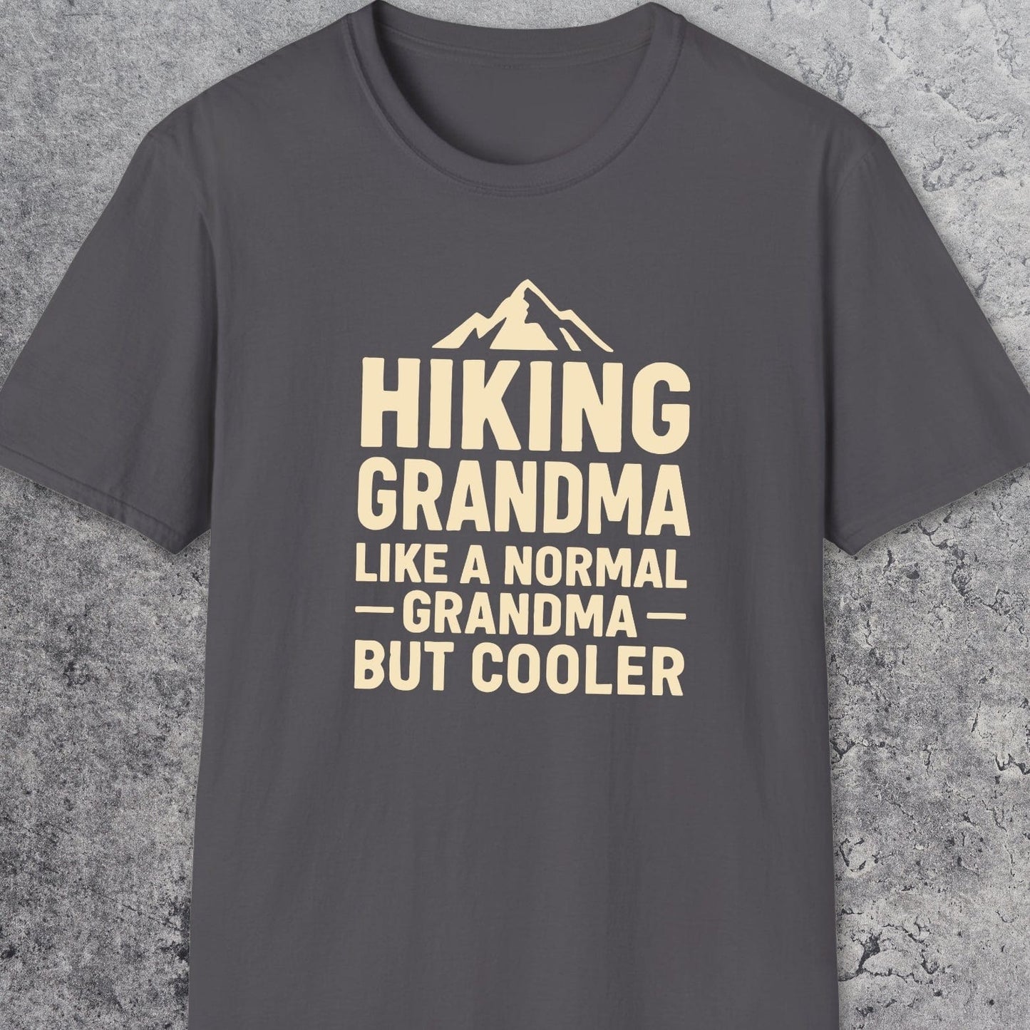 Hiking Grandma T-Shirt featuring a mountain silhouette and playful text. Made from soft ring-spun cotton with durable DTF prints, perfect for outdoor enthusiasts.