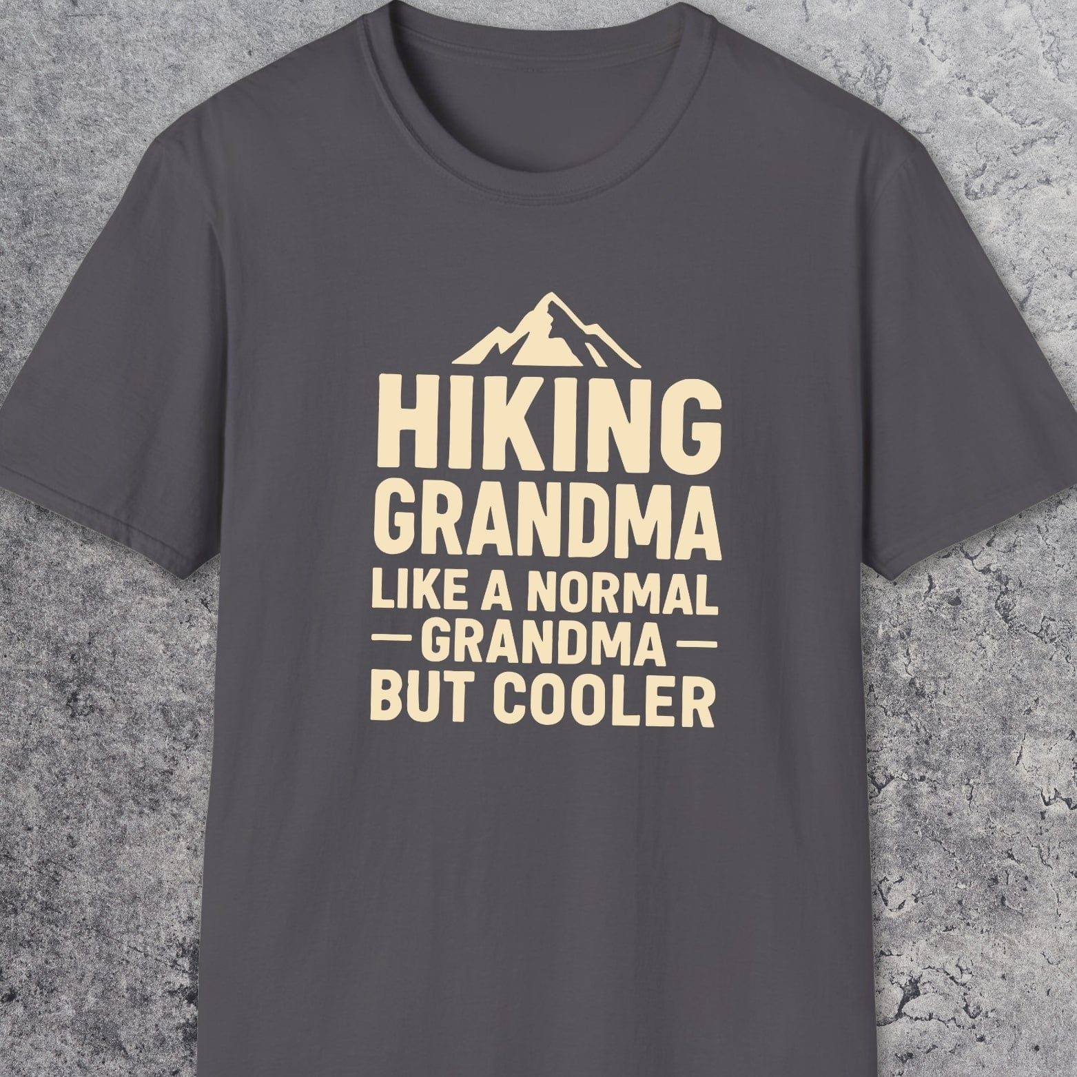 Hiking Grandma T-Shirt featuring a mountain silhouette and playful text. Made from soft ring-spun cotton with durable DTF prints, perfect for outdoor enthusiasts.