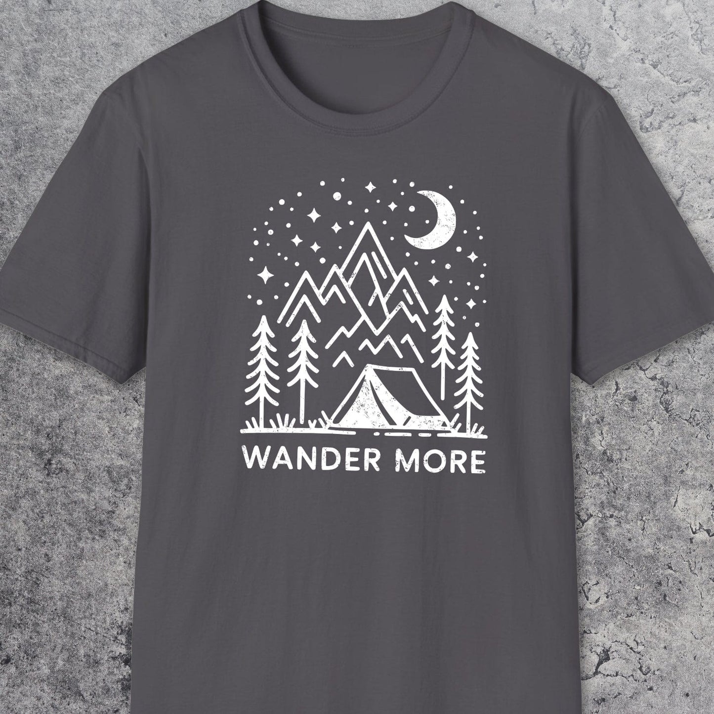 Wander More T-Shirt featuring a white outdoor scene with pine trees, tent, mountains, and starry sky on dark-gray, crafted for comfort and adventure.