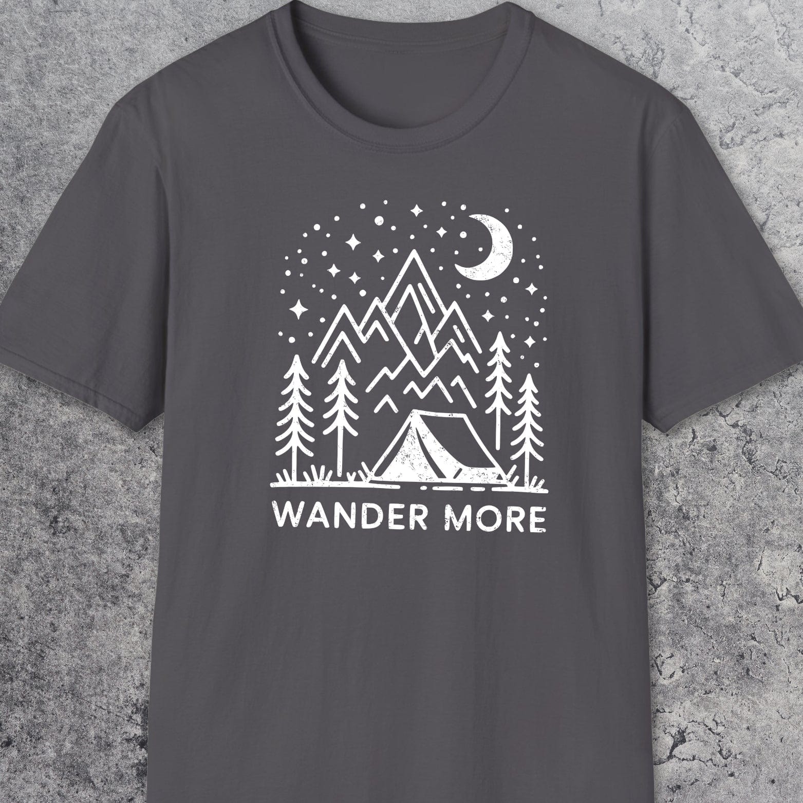 Wander More T-Shirt featuring a white outdoor scene with pine trees, tent, mountains, and starry sky on dark-gray, crafted for comfort and adventure.