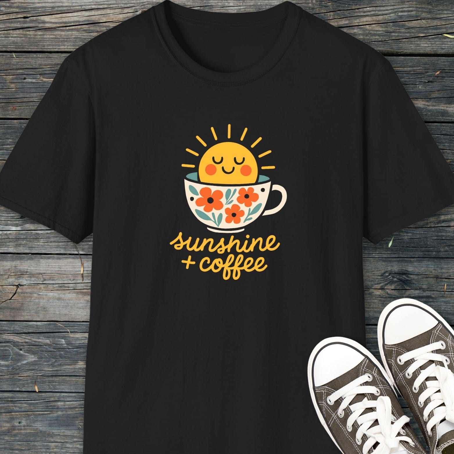 Sunshine And Coffee T-Shirt featuring a sun in a coffee cup graphic. Made of soft, lightweight cotton, ideal for various activities. Paired with canvas sneakers.