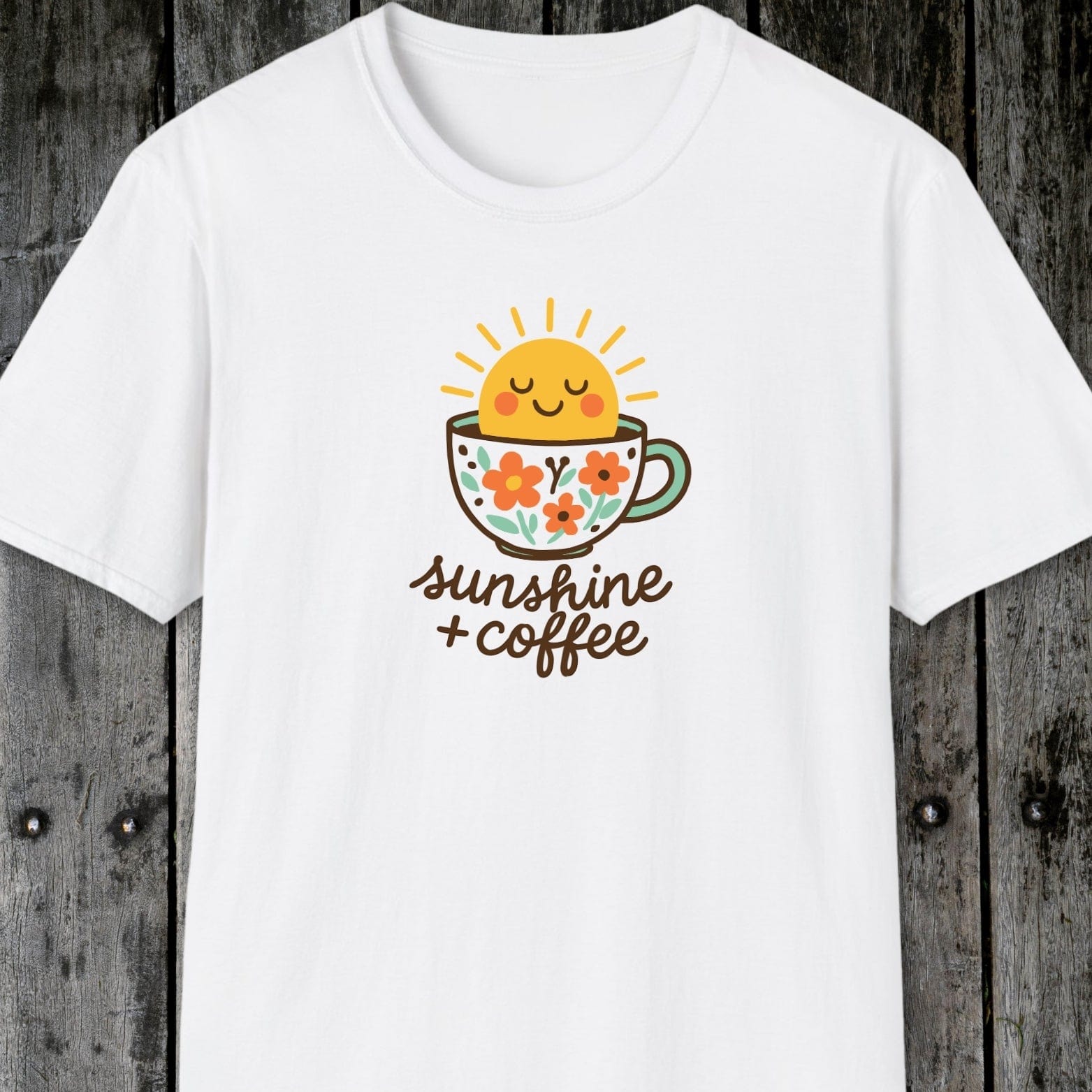 Sunshine And Coffee T-Shirt featuring a smiling sun and floral coffee cup graphic. Soft, lightweight cotton, unisex fit, perfect for adventures and casual wear.
